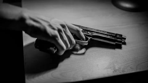 Grabbing a gun from the table, violence Stock Footage 132154501