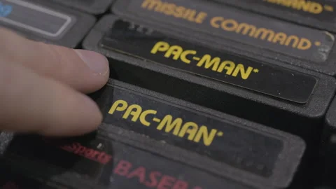 Grabbing PAC-MAN Atari game cart to purchase 4k Stock Footage 241127865