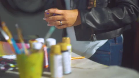 Grabbing paint off a shelf Stockbeeldmateriaal 171724584