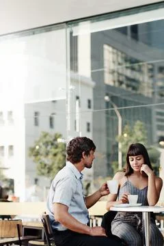 Grabbing a quick coffee on their first date Stock Photos