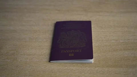 Grabbing Red British Passport Stock Footage 132994616