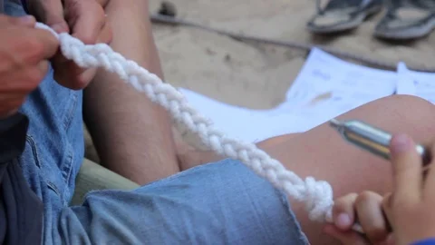 Grabbing the rope to tie it Stock Footage 73783078