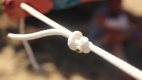 Grabbing the rope to tie it Stock Footage 74508768