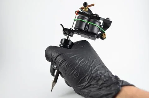 Grabbing Tattoo Machine 库存照片