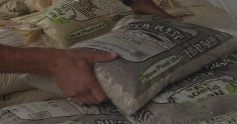 GrabbingBagsOfSand Stock Footage 88838695