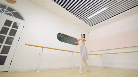 A graceful ballerina ballet dancer training in studio perform elegant pose Stock Footage 332388944