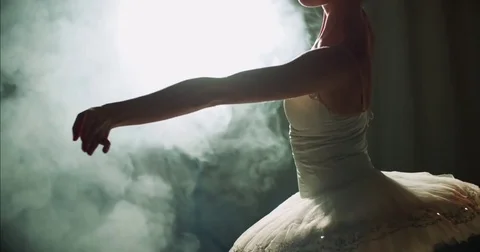 Graceful ballerina dancing elements of classical ballet in the dark with light Stock Footage 73423625