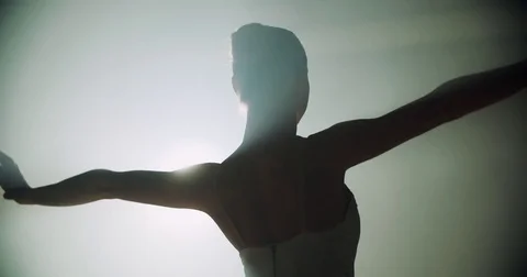 Graceful ballerina dancing elements of classical ballet in the dark with light Stock-Footage 73423873