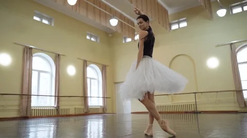 Graceful ballerina dancing elements of classical ballet in the dance studio Stock Footage 270502571