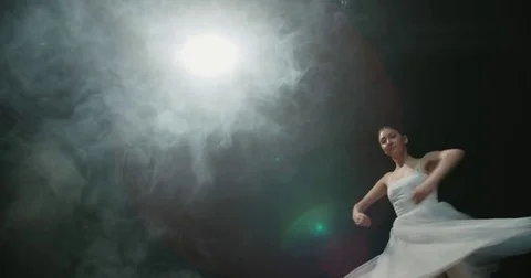 Graceful ballerina during the training in the Studio. Smoke, fog, slow motion Stock Footage 85044334