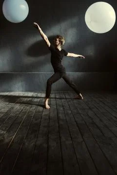 Graceful ballet dancer performing in the decorated studio Stock Photos