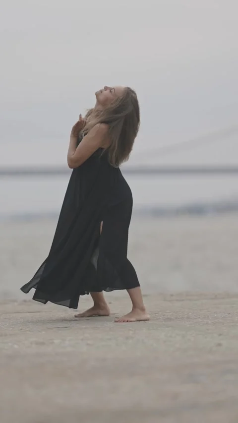 Graceful barefoot dancer performing on the beach Stock Footage 317537146