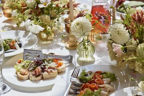 Graceful chambers table setting, arranged flowers with natural light. Cozy Stock Photos