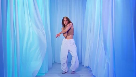 Graceful Contemporary Dance Surrounded by Soft Blue Curtains Stock Footage 306315933