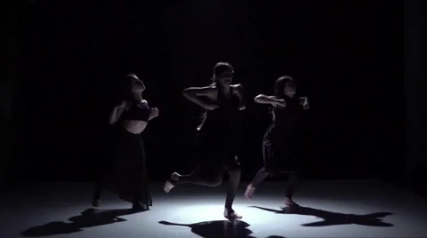 Graceful contemporary dance of three dancers on black, shadow, slow motion Stock Footage 61179277