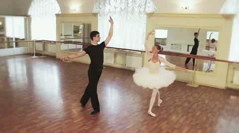 Graceful couple dancing ballet simultaneously in front of mirror Stock Footage 40283686