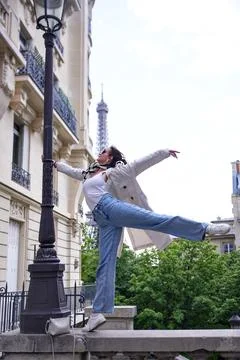 Graceful dancer performing on Paris street with Eiffel Tower view Stock Photos
