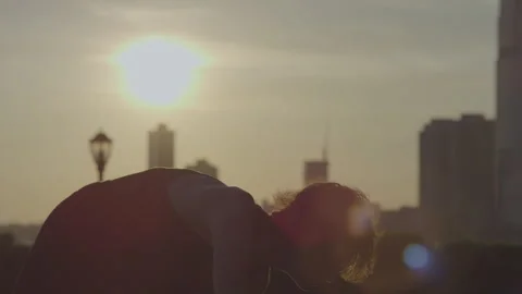 Graceful dancer performs ballerina balance at sunset in urban setting Stock Footage 312622405