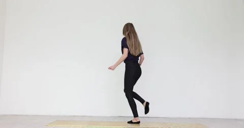 Graceful dancer practicing traditional Irish dance steps on mat Stock Footage 309052169