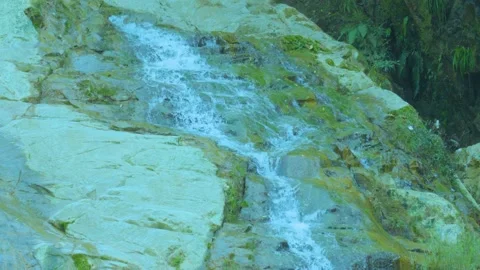Graceful Descent: Water Flowing Down a Rocky Path Stock Footage 282081433