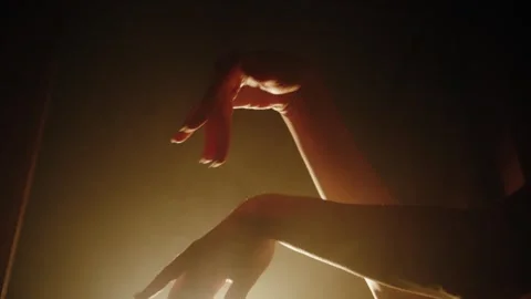 Graceful hands in dramatic lighting Stock Footage 297766743
