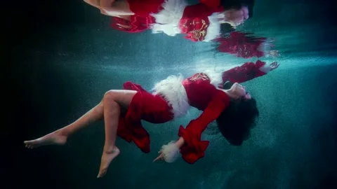 Graceful lady in red is floating underwater, sexy female figure in clear water 스톡 동영상 176237295