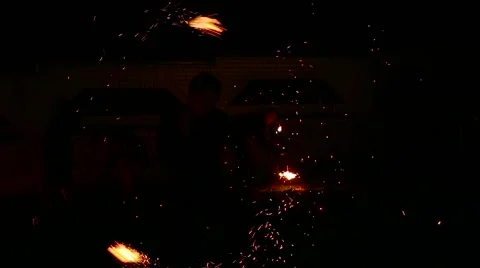 Graceful man dancing passionate dance with fire fan in his hand. Fire show Stock Footage 66002246