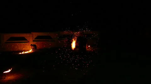 Graceful man dancing passionate dance with fire fan in his hand. Fire show Stock Footage 66199756