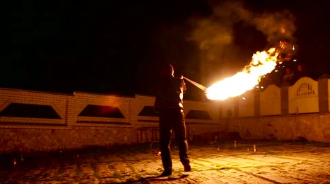 Graceful man dancing passionate dance with fire fan in his hand. Fire show Stock Footage 66200418