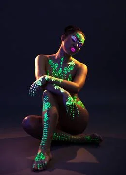 Graceful model posing with UV pattern on body Graceful model posing with g... Stock Photos