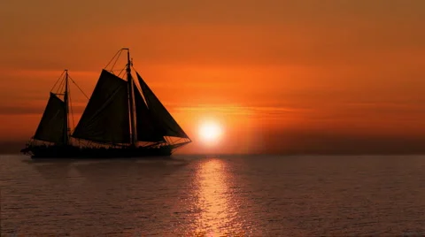Graceful Sailboat Glides by Sunset/Sunrise. Stock Footage