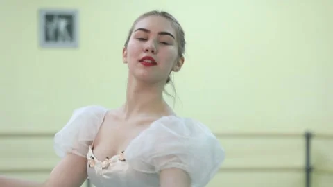 Graceful young ballerina dancing elements of classical ballet Stock Footage 148233054