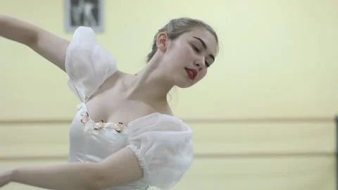 Graceful young ballerina dancing elements of classical ballet Video stock 148233066