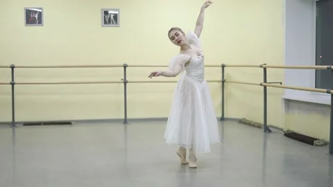 Graceful young ballerina dancing elements of classical ballet Stock Footage 148233118