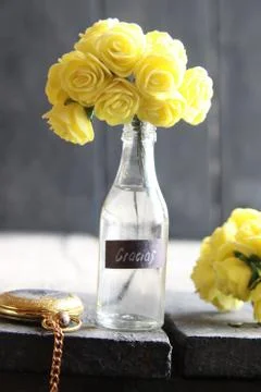 Gracias label and Flowers in a glass bottle Stock Photos