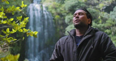 Graded C4K 120fps Man at waterfall inhaling deeply Stock Footage 136544978