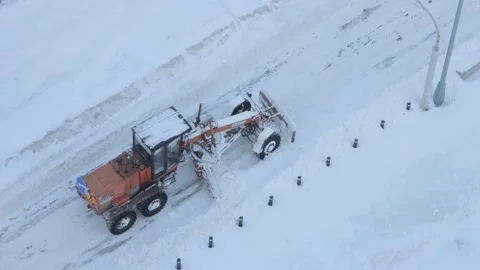 Grader clearing snow from a road Stock Footage 287601187