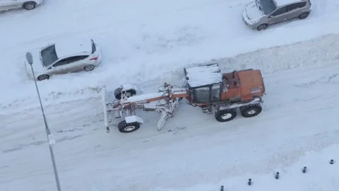 Grader clearing snow from a road Stock Footage 287601245