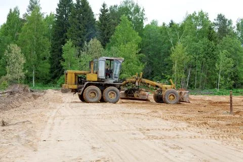 The grader clears away a ground Stock Photos