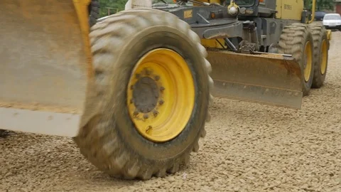 Grader excavator spread the crushed stone on the road Stock Footage 76671798