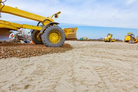 Grader is leveling fraction over construction site Stock Photos