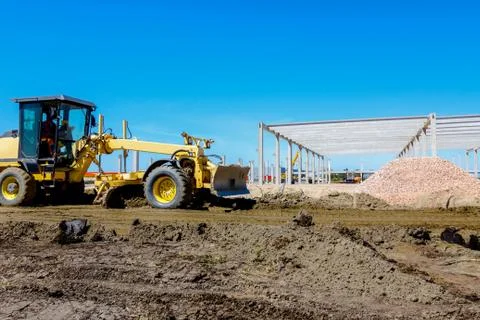 Grader is leveling ground at construction site Stock Photos