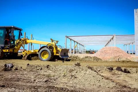 Grader is leveling ground at construction site Stock Photos