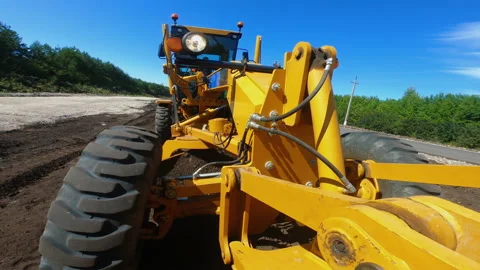 Grader is leveling ground, working at construction of new road, onboard camera Video stock 159156924