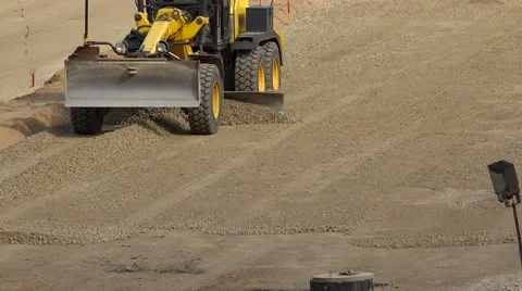 Grader machine leveling gravel rubble on road construction site Stock Footage 68757437
