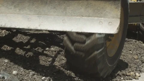 Grader machinery pushes and distributes gravel during roadworks, scoop close up. Stock Footage 76989590