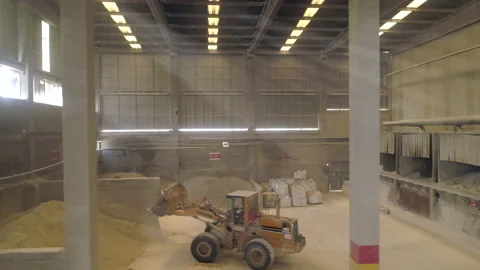 Grader Moving Clay Soil in Ceramic Factory Warehouse Stock Footage 166696668