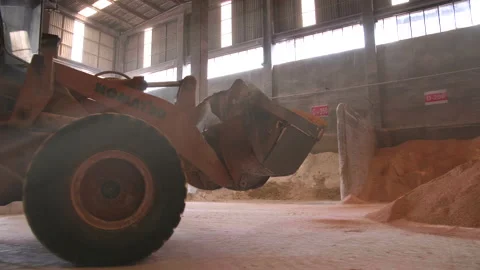 Grader Moving Clay Soil in Ceramic Factory Warehouse Stock Footage 166696776