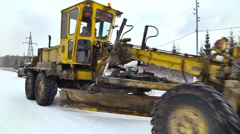 Grader Moving on the Road. Winter Forest. Close up Stock Footage 65786201