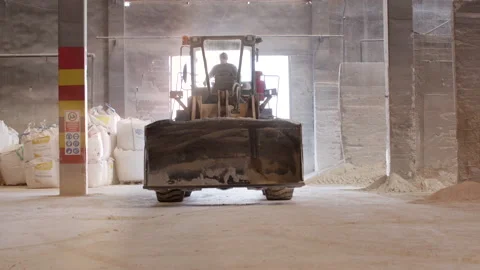 Grader Moving Towards Camera in Ceramic Factory Warehouse 스톡 동영상 166696912